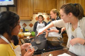 Becca Hetrick (far right) stirs the soup she’s making as Millika Kodavataganti (far left) watches her; behind them, Victoria Corado (center) and Emily Liesch (left of Hetrick) work on the cream of cauliflower soup on January 21st, 2016. All four of them were excited to eat their meals afterwards. 