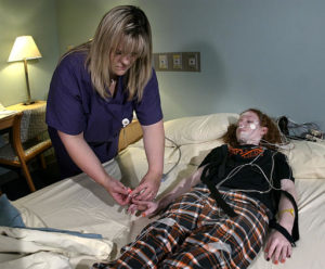 Polysomnographic specialist Kyndra Vanderheyden, left, connects sensors to Cara Horton, 16, as Horton prepares to spend the night at the Sleep Disorders Center at St. Luke's Hospital in Kansas City, Mo., Sunday, Oct. 3, 2004. Horton is among a growing number of teens suffering from insomnia or other sleep disorders. (AP Photo/Charlie Riedel)