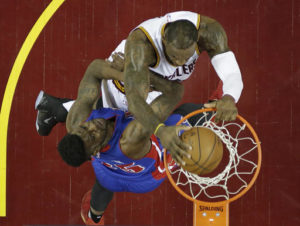 Cleveland Cavaliers' LeBron James, top, dunks the ball against Detroit Pistons' Reggie Bullock in the first half in Game 2 of a first-round NBA basketball playoff series, Wednesday, April 20, 2016, in Cleveland. (AP Photo/Tony Dejak)