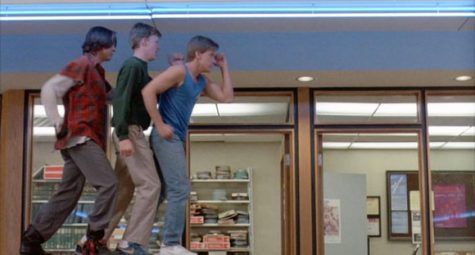 John, Brian, and Andrew dance in the library. The kids put-on an 80s montage. (Photo courtesy of Universal Pictures)