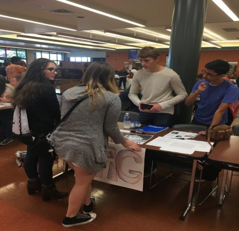 Sawyer Smith (middle right) and Varun Sharma (far right) explaining what YAG is like to Damla Undar (far left) and Stella Del Carmen (middle left) at clubfest in the cafeteria of HHS. The Youth and Government members explained the events that they were looking forward to: the model and the election convention. (Broadcaster/Evan Spinney) 