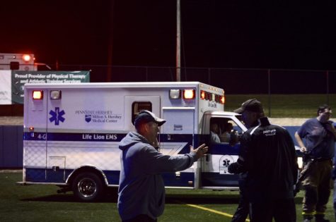 A Penn State Hershey Life Lion EMS ambulance drives onto the field. A referee had collapsed due to an apparent heart attack. The referee left in an ambulance but was responsive. (Broadcaster/Azelin Thompson)