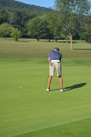 Junior, Patrick Larkin, sinks a putt to earn him the second ranking spot. The Trojans played at the Manada Golf course on Thursday, September 22, 2016. (Broadcaster/ Mallory Drayer)
