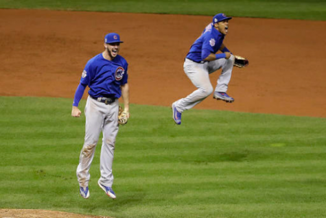 Chicago Cubs' Kris Bryant, left, and Addison Russell begin to celebrate after the final out of Game 7 of the Major League Baseball World Series against the Cleveland Indians Wednesday, November 2, 2016, in Cleveland. Chicago won 8-7 in ten innings. (AP Photo/Gene J. Puskar)