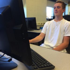 Sophomore Alec Singer working on a new computer in the Engineering Lab on September 24th 2015. The install was completed 2 weeks before school started.