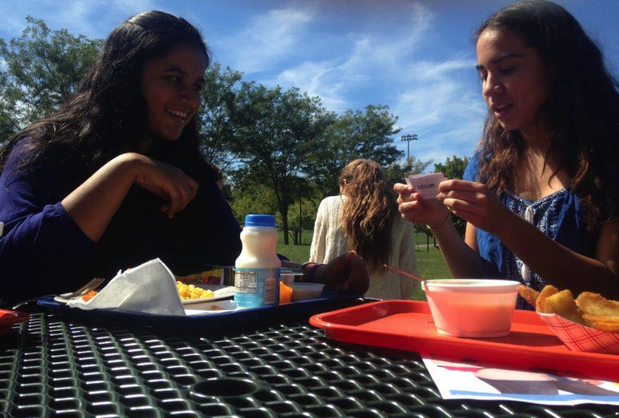 Sophomores Daniela Farias (right) and Fatima Asghar (left) study for a chemistry test on  November 23, 2015. Using flashcards to practice vocabulary, Farias and Asgar steal bites of lunch at Hershey High School, in Hershey, Pennsylvania. 