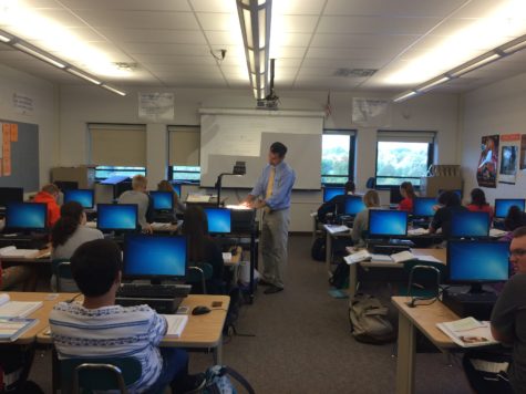 Gustantino, center, teaches his Accounting l class about how to put information into a General Journal Wednesday, Oct. 7, 2015. He presented the answers to the worksheet using the projector for the convenience of students. 