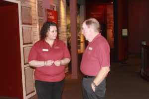 Caroline Sandoval, left, talks with her colleague William Uffelman, right, at The Hershey Story Museum in Hershey, PA on Wednesday, September 23rd, 2015. Sandoval supports two people on her job at The Hershey Story, whereas Uffleman is retired and works this job primarily to keep busy.