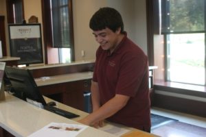 Brendan Demmy organizes materials at the front desk of The Hershey Story Museum in Hershey, PA on Thursday, October 8th, 2015. Demmy is responsible for explaining the types museum attractions that are offered to the guests. 
