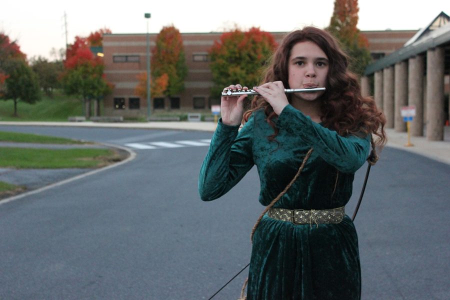Emily Nothnagle plays her flute outside of HHS, on October 20th, 2015. Her ‘Merida’ costume was chosen because of the similarity between the characters hair, and Nothnagle’s hair. 
