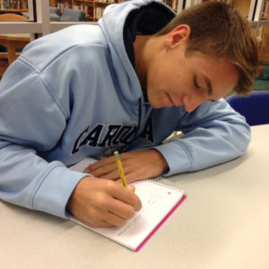 Junior Jake Hedrick writes in a journal on October 9, 2015. Hedrick has completed plenty of research on the Naval Academy.