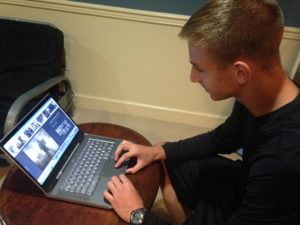 Mark Suminski looks up Naval SEAL pictures on his laptop on October 9, 2015. Suminski has posted many pictures on his basement wall as inspiration.