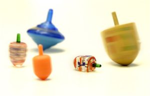 FILE-This Nov. 15, 2006 file photo shows  toy dreidels spinning and falling  in New York.  (AP Photo/Seth Wenig,File)