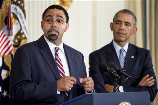 Senior Education Department official, John King Jr., left, accompanied by President Barack Obama, speaks in the State Dining Room of the White House in Washington, Friday, Oct. 2, 2015, after Obama announced that Education Secretary Arne Duncan will be stepping down in December after 7 years in the Obama administration. Duncan will be returning to Chicago and Obama has appointed King, to oversee the Education Department. (AP Photo/Andrew Harnik)