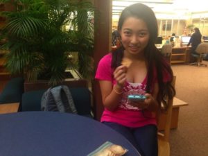 Kathy Li, a sophomore at Hershey High School, ate breakfast at school on October 9, 2015. Li was passing the time before first period, by waking up and checking her phone.