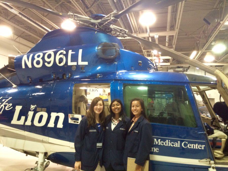 (From left to right) Seniors Julia Corbin, Sareena Fayaz, and Alexis Gazzio pose for a picture in front of the Life Lion Helicopter on September 18th, 2015. These three hope to get into a superior college medical program through HCEP. (Photo submitted by Julia Corbin)