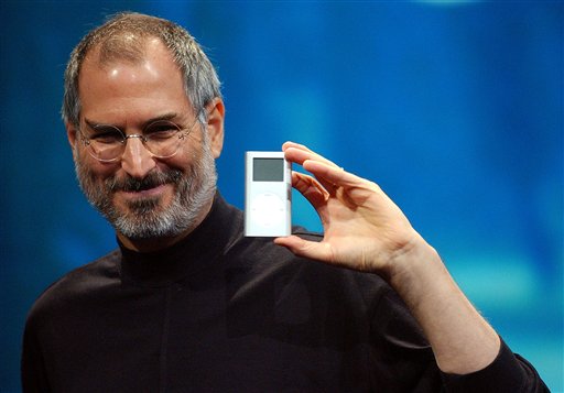 In this Jan. 6, 2004 file photo, Apple CEO Steve Jobs displays the iPod mini at the Macworld Conference and Expo in San Francisco. Jobs, the Apple founder and former CEO who invented and masterfully marketed ever-sleeker gadgets that transformed everyday technology, from the personal computer to the iPod and iPhone, died Wednesday. He was 56. (AP Photo/Marcio Jose Sanchez, File)