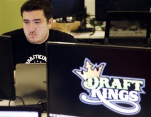 FILE - In this Sept. 9, 2015 file photo, Len Don Diego, marketing manager for content at the DraftKings daily fantasy sports company, works at his station at the company's offices in Boston. Daily fantasy sports companies have said their industry remains viable despite a rocky start to 2016.  ESPN and DraftKings ended an exclusive advertising deal, and FanDuel confirmed it was laying off 55 workers in its Orlando, Fla., office. (AP Photo/Stephan Savoia, File)
