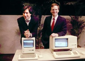 FILE -This January 1984, file photo, shows Apple CEO Steven P. Jobs, left and President John Sculley presenting the new Macintosh Desktop Computer in January 1984 at a shareholder meeting in Cupertino, Calif. January 24, 2014, marks thirty years after the first Mac computer was introduced, sparking a revolution in computing and in publishing as people began creating fancy newsletters, brochures and other publications from their desktops. (AP Photo/FILE)