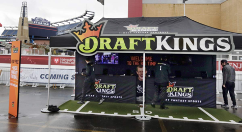 In this Oct. 25, 2015, photo, workers set up a DraftKings promotions tent in the parking lot of Gillette Stadium, in Foxborough, Mass., before an NFL football game between the New England Patriots and New York Jets. New Yorks attorney general on Tuesday, Nov. 10, 2015, ordered the daily fantasy sports companies DraftKings and FanDuel to stop accepting bets in the state, saying their operations amount to illegal gambling. (AP Photo/Charles Krupa, File)