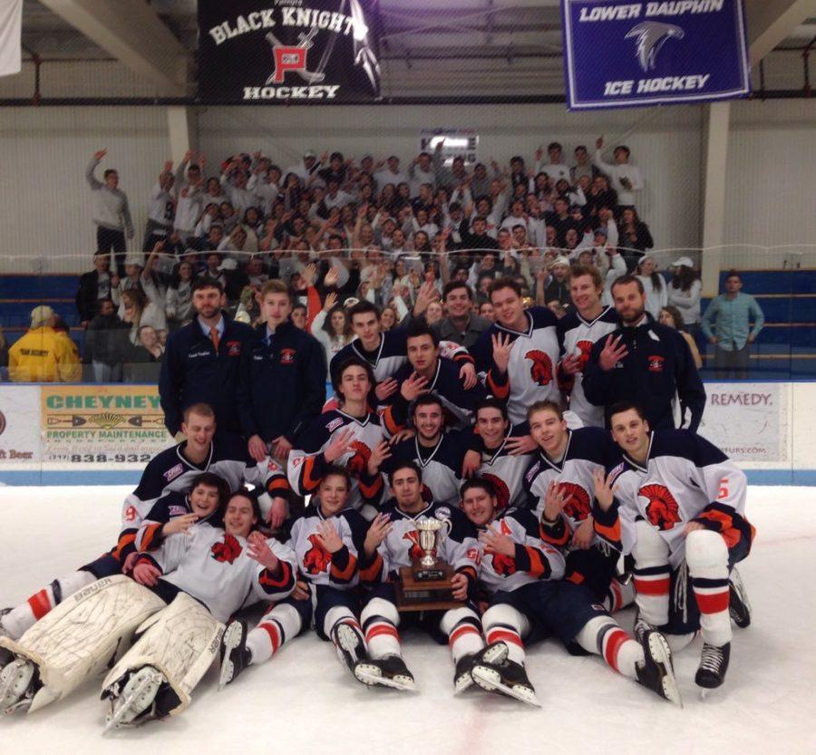 Hershey Boys hockey team pose for a picture featuring the Merriman-Weare cup, and the Hershey High Student section. The Trojans have won the cup for four years in a row (photo courtesy of Hershey Boys Ice Hockey twitter @Hershey_Hockey)
