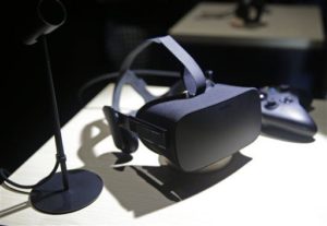 In this June 11, 2015, file photo, the new Oculus Rift virtual reality headset is on display following a news conference in San Francisco. The much-hyped Oculus Rift virtual reality headset will cost $599 and ship to 20 countries beginning on March 28, the company said Wednesday, Jan. 6, 2016. (AP Photo/Eric Risberg, File) 