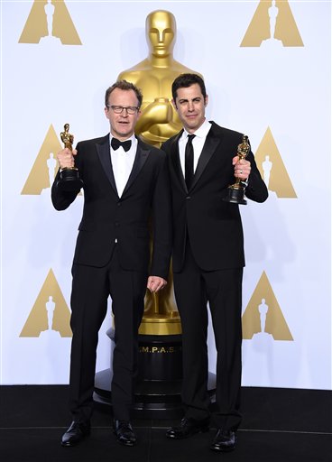 Tom McCarthy, left, and Josh Singer pose with the award for best original screenplay for Spotlight in the press room at the Oscars on Sunday, Feb. 28, 2016, at the Dolby Theatre in Los Angeles. (Photo by Jordan Strauss/Invision/AP)