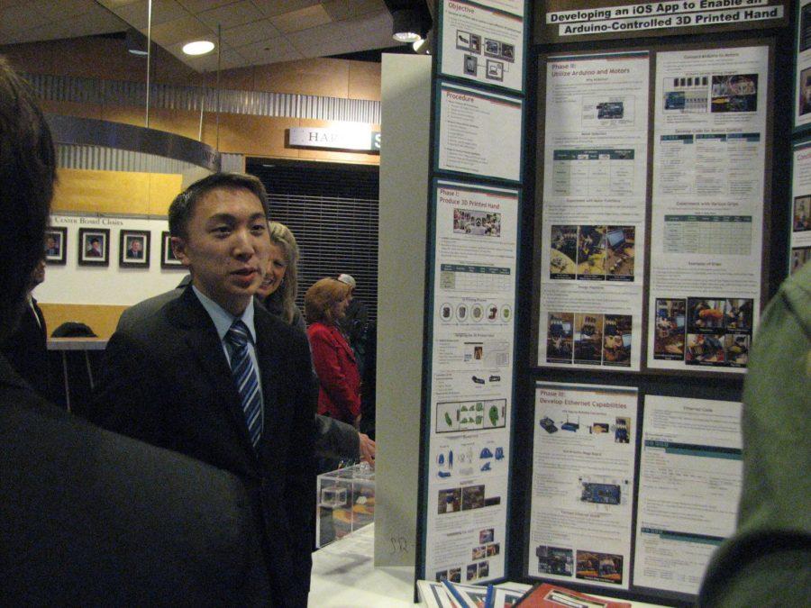 Junior Alan Hwang explains his project, entitled “iOS App: Enable an Aruduino-Controlled 3D Printed Hand,” to onlookers. Hwang was awarded Grand Champion of the Capital Area Science & Engineering Fair for his work. (Broadcaster/Emily Briselli)