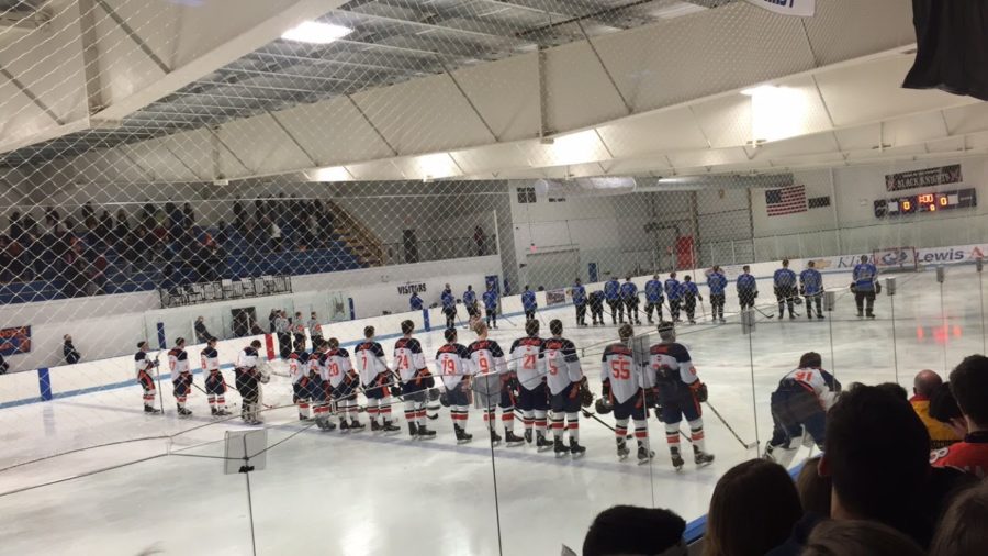 Hershey Trojans and Cedar Crest Falcons stand and listen to the National Anthem before the puck drop. The Trojans beat the Falcons 4-2 on Friday, February 26, 2016.  