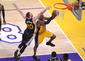 Los Angeles Lakers forward Kobe Bryant, right, shoots as Utah Jazz forward Gordon Hayward defends during the second half of an NBA basketball game, Wednesday, April 13, 2016, in Los Angeles. Bryant scored 60 points in his final NBA game as the Lakers won 101-96. (AP Photo/Mark J. Terrill)