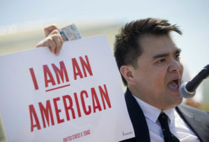 Jose Antonio Vargas, a journalist, filmmaker, and immigration rights activist, from San Francisco, holds up his California Driver's License as he speaks to supporters of fair immigration reform gather in front of the Supreme Court in Washington, Monday, April 18, 2016. The Supreme Court is taking up an important dispute over immigration that could affect millions of people who are living in the country illegally. The Obama administration is asking the justices in arguments today to allow it to put in place two programs that could shield roughly 4 million people from deportation and make them eligible to work in the United States. (AP Photo/Pablo Martinez Monsivais)