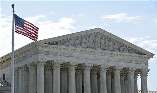 The American flag flies in the wind in front of the Supreme Court in Washington, Monday, June 22, 2015. (AP Photo/Susan Walsh)