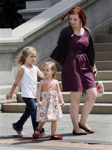 Six-year-old transgender girl Coy Mathis, left, her sister Auri and mother Kathryn Mathis walk to a news conference at the Capitol in Denver on Monday, June 24, 2013. The Colorado Civil Rights Division has ruled in favor of six-year-old Coy Mathis, whose school had barred her from using the girls bathroom at her elementary school because she is transgender. (AP Photo/Ed Andrieski)