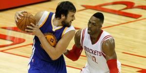 Golden State Warrior Andrew Bogut prepares to drive to the basket against, Dwight Howard, on April 18, 2016. The Warriors edged Houston in that game 115-106. (via Twitter / @warriors) 