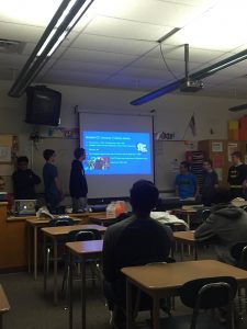The members of HHS superhero club (from left to right, Noah Spochart, Pavan Patel, Hagan Seley, Joe Laflam, Sam Allery, Matt Davis, Keilen Olsen) present information about the DC movieverse. The presentation was informational and filled with fun facts like there have been eight different screen versions of Batman. 