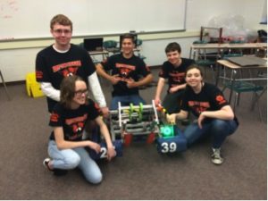 The Krypton Cougars pose for a team picture with their robot on Community Day on April 29, 2016. The team had put in numerous hours to create their robot, which can shoot balls and move around on wheels. (Broadcaster/Jenny Kim)