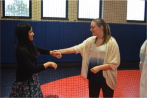 Freshmen, Elaina Lamb and Heather Marra, practice their self defense moves during the “Ladies, Can You Defend Yourself?” session on Community Day. (Broadcaster/Cara McErlean)