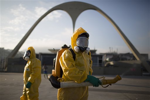 A health workers stands in the Sambadrome spraying insecticide to combat the Aedes aegypti mosquito that transmits the Zika virus in Rio de Janeiro, Brazil on Jan. 26, 2016. The Sambadrome will be used for the Archery competition during the 2016 Olympic games. With the opening ceremony less than three months away, a Canadian professor has called for the Rio Olympics to be postponed or moved because of the Zika outbreak, warning the influx of visitors to Brazil will result in the avoidable birth of malformed babies. The IOC and World Health Organization disagree, saying Zika will not derail the games.   (AP Photo/Leo Correa, File)