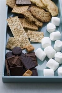 In this image taken on April 29, 2013, ingredients for making toasted mocha s'more, salted oatmeal s'more, sesame caramel s'more, and double chocolate grasshopper s'more are shown on a tray in Concord, N.H. (AP Photo/Matthew Mead)