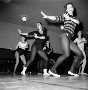 Thirty-six girls, dancing as one on the huge stage of New Yorks Radio City Music Hall on Oct. 15, 1958, are the envy of many other girls throughout the United States. The dancers are the celebrated Rockettes. One of the dancers, Mary Ann Strilka of Olyphant, Pa., in a black leotard, white ballet slippers and socks is caught by the camera in some of the behind-the-scenes work at the theater. (AP Photo/Anthony Camerano)