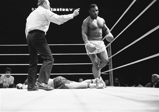 Ref Arthur Mercante points the way to the neutral corner for Mike Tyson, right, after he knocked down Steve Zouski in the third round of ten rounder at the Nassau Coliseum in Uniondale, New York, Monday, March 11, 1986. Mercante stopped the fight after the knockdown and Tyson had a TKO win. (AP Photo/Ray Stubblebine)