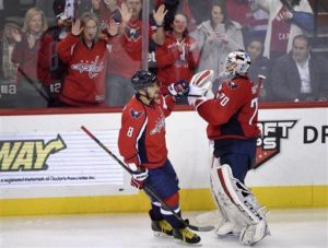 Washington Capitals left wing Alex Ovechkin (8), of Russia, celebrates his goal with goalie Braden Holtby(70) during the third period of an NHL hockey game against the Minnesota Wild, Friday, Feb. 26, 2016, in Washington. The Capitals won 3-2. (AP Photo/Nick Wass) 