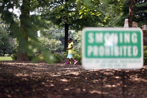  Ariayanna Stinson, 6, of Atlanta, walks around the playground next to a smoking prohibited sign in Woodruff Park, Friday, July 26, 2013, in Atlanta. No Smoking signs are going up in parks, beaches and other outdoor venues across the country, but some experts are questioning whether theres enough medical evidence to support the trend. (AP Photo/Jaime Henry-White)