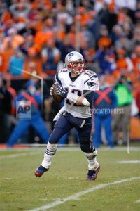 Patriots quarterback Tom Brady looks for an open receiver during a playoff game against the Denver Broncos, on January 24, 2016. Brady was recently suspended for the first four games of the 2016 NFL season. (AP Images)