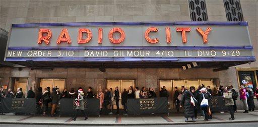 Rockettes hopefuls line up outside Radio City Music Hall waiting to audition for Rockettes New York Spectacular on Tuesday, Feb. 23, 2016, in New York. Dancers hope to land a spot in the summertime production from June 15 through Aug. 7, 2016. (AP Photo/Bebeto Matthews)

