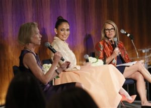 Jennifer Lopez, Global Advocate for Girls and Women at the UN Foundation, center, and Katie Couric, Yahoo! Global News Anchor, right, look on as Kathy Calvin, President and CEO of the UN Foundation speaks at the Right Smart Now: Investing in Girls, Women and Gender Equality dinner in New York, Friday, Sept. 25, 2015. The dinner brought together experts and advocates to discuss the centrality of gender equality to achieving the new global goals. (Stuart Ramson/AP Images for United Nations Foundation)