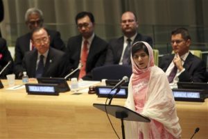 United Nations Secretary-General Ban Ki-moon, left, listens as  Malala Yousafzai, right, addresses the "Malala Day" Youth Assembly, at United Nations headquarters on Friday, July 12, 2013. A year ago, Malala Yousafzai was a schoolgirl in northwest Pakistan, thinking about calculus and chemistry, Justin Bieber songs and "Twilight" movies. Today she's the world-famous survivor of a Taliban assassination attempt, an activist for girls' education _ and a contender to win the Nobel Peace Prize on Friday Oct. 11, 2013. (AP Photo/Mary Altaffer, File)