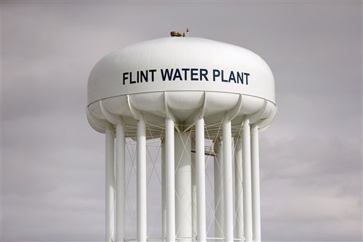 In this Feb. 26, 2016, photo, the Flint Water Plant tower is seen in Flint, Mich. The state-appointed emergency manager who oversaw Flint, Michigan when its water source was switched to the Flint River says he was grossly misled by state and federal experts who never told him that lead was leaching into the citys water supply. (AP Photo/Paul Sancya)