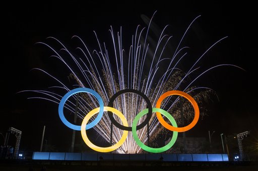 Fireworks explode behind the Olympic rings during their inauguration at the Madureira Park in Rio de Janeiro, Brazil, Wednesday, May 20, 2015. The rings are a gift from the city of London. (AP Photo/Felipe Dana)