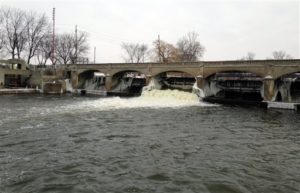 Water from the Flint River flows over a dam in Flint, Mich. A decision to switch the Flint's drinking water source to the river led to corroded pipes that leached lead and other dangerous substances and sickened residents. (AP Photo/Matt Sedensky)
